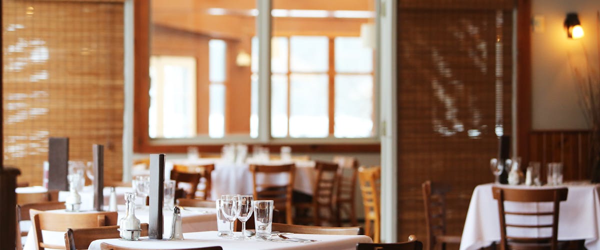 Busy restaurant dining room with occupied tables during peak hours